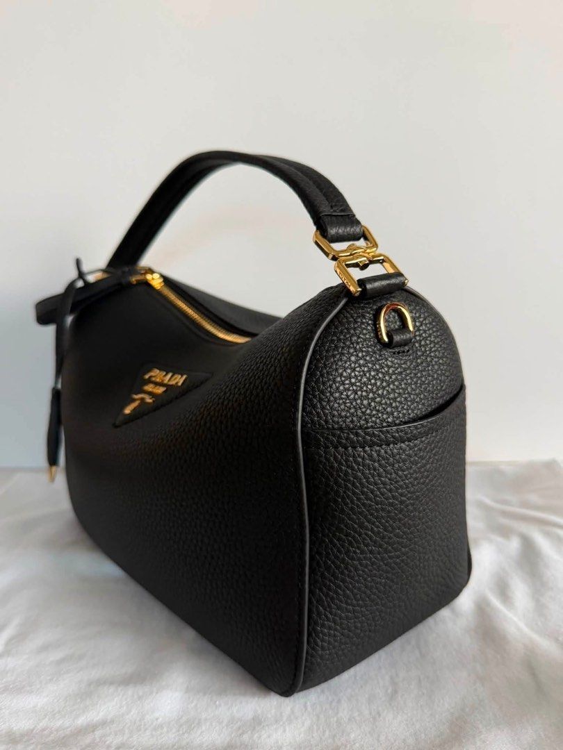 Preloved Prada Leather Handbag (Category: Luxury Bags & Wallets) located in Manila. Submitted by bagsandshoesmanymore (Listing ID 1434187496, Image 3). Description: - Authentic Prada handbag -Size 24cm -RiRi zipper - Top handle and detachable shoulder strap - Gold-tone hardware - Prada-branded interior lining - Interior zippered pocket - Prada logo on fronts Please read before you order 👉🏻❗️Payment first before shipping ❗️Cut off time of paymen