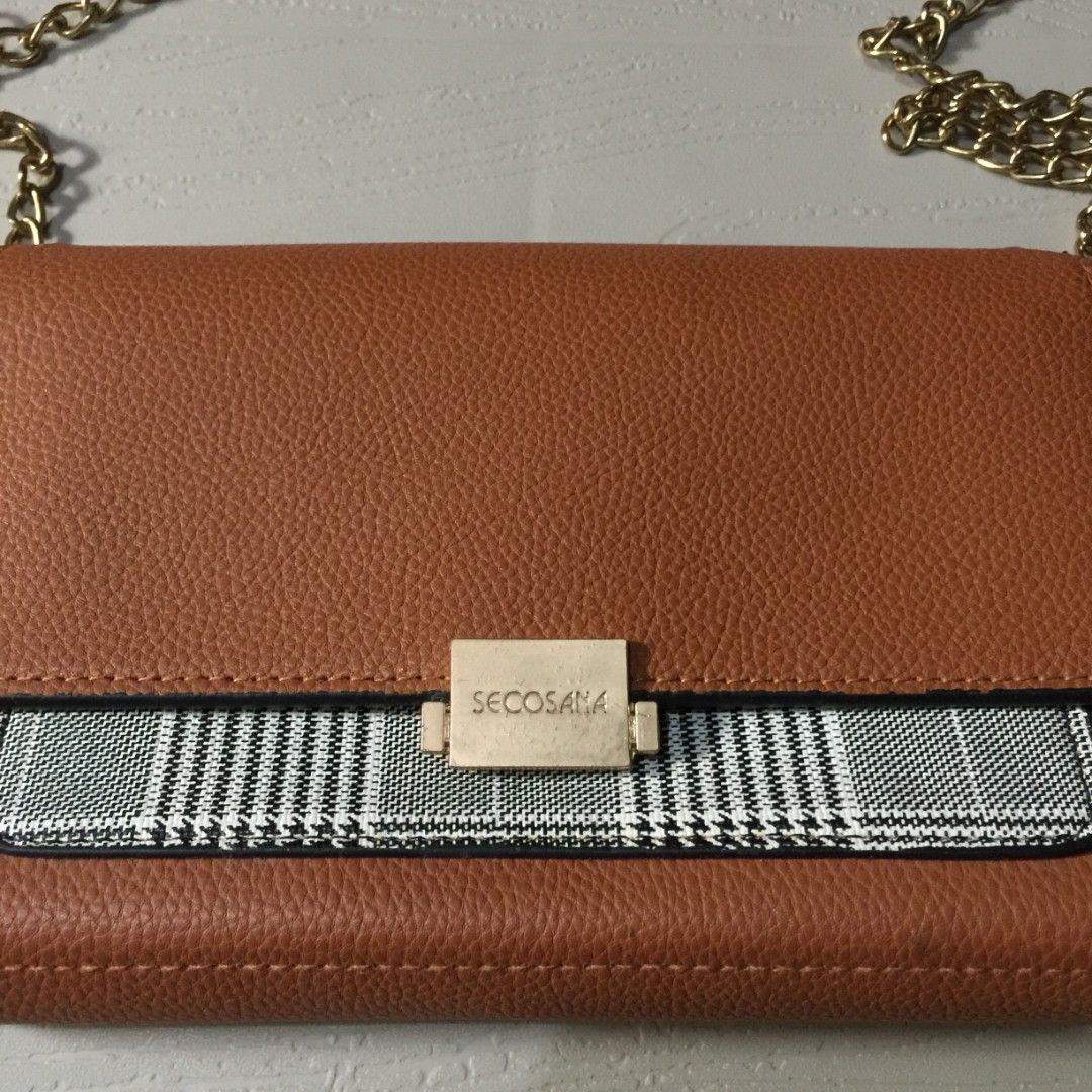 Secosana Brown Tan Sling Bag Chain Shoulder Strap (Category: Cross-body Bags) located in Pasig City. Submitted by butfirst.declutter (Listing ID 1454031085, Image 2). Description: - Lightly used - Only issue, replaced one chain, vsee photo - No dents - Color may vary due to lighting - See photos for measurements - Manage your expectations since this is a preloved item. You can message me for inquiries. Kindly read my ‘About’ :> Price is negotiabl