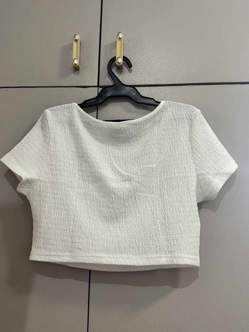 SHEIN White Textured Square Neck Crop Top (Category: Blouses) located in Quezon City. Submitted by jaebaeee (Listing ID 1454141030, Image 3). Description: - White textured crop top from SHEIN - Features a square neckline and short sleeves - Unique crinkled fabric texture - Cropped length, ideal for pairing with high-waisted bottoms - Versatile for casual outings.