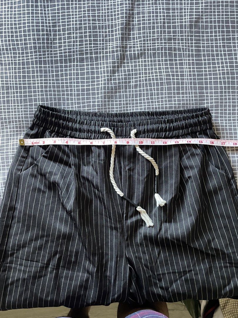 Striped Wide Leg Pants with Drawstring Waist (Category: Other Bottoms) located in Mandaluyong City. Submitted by elmo_7 (Listing ID 1454037297, Image 2). Description: - Classic black and white pinstripe pattern - Trendy wide-leg cut for a relaxed and comfortable fit - Easy pull-on style with elastic waistband and adjustable white drawstring - Convenient side pockets - Perfect for versatile styling - dress them up or down! - Measurements: Waist (u