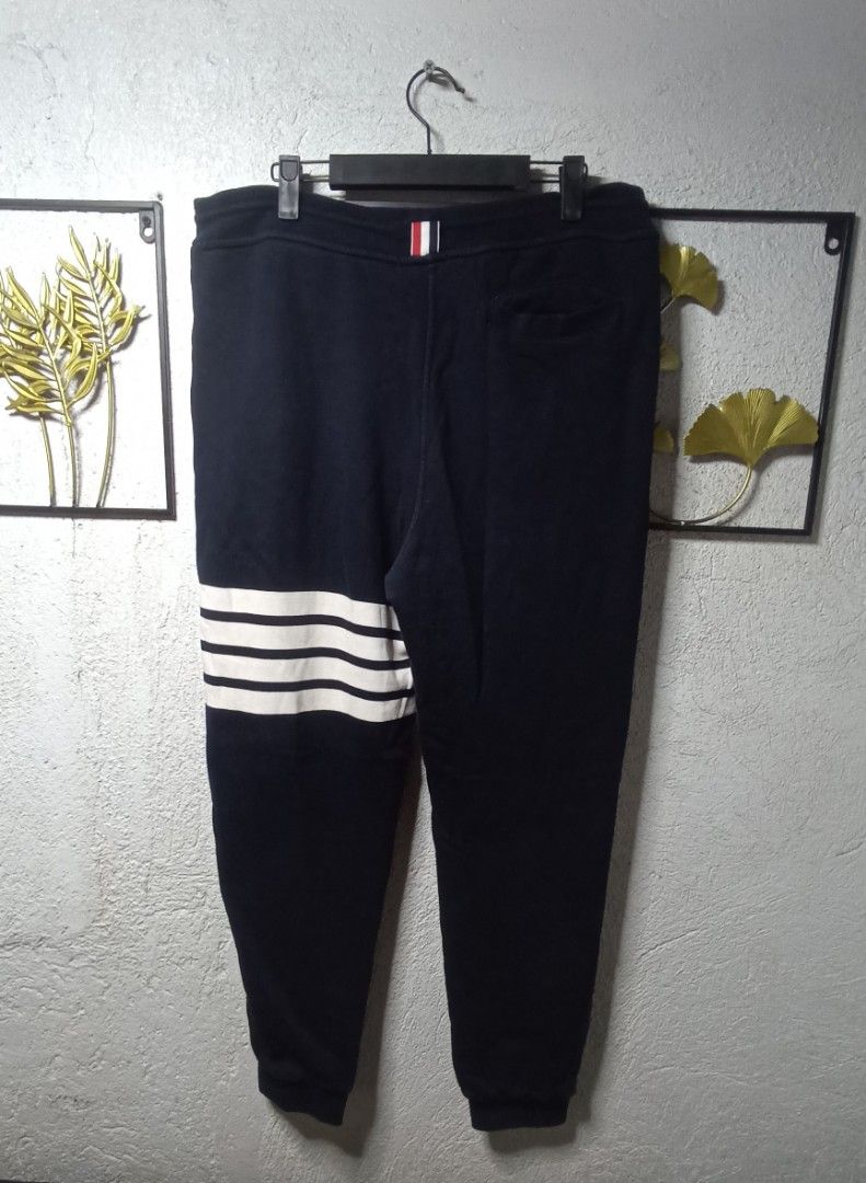 Thom Browne Navy Sweatpants Size 4 (Category: Joggers) located in Kawit. Submitted by deidzdzn (Listing ID 1454114507, Image 3). Description: - Authentic Thom Browne Navy Sweatpants - Size: 4 - Signature white stripes on the side - Elastic waistband with drawstring - Made in Japan - Measurements: Waist 34/36, Length 40.