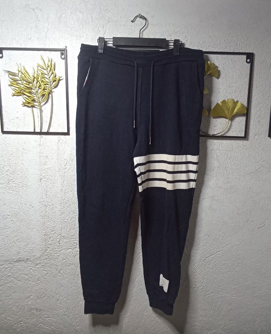 Thom Browne Navy Sweatpants Size 4 (Category: Joggers) located in Kawit. Submitted by deidzdzn (Listing ID 1454114507, Image 2). Description: - Authentic Thom Browne Navy Sweatpants - Size: 4 - Signature white stripes on the side - Elastic waistband with drawstring - Made in Japan - Measurements: Waist 34/36, Length 40.