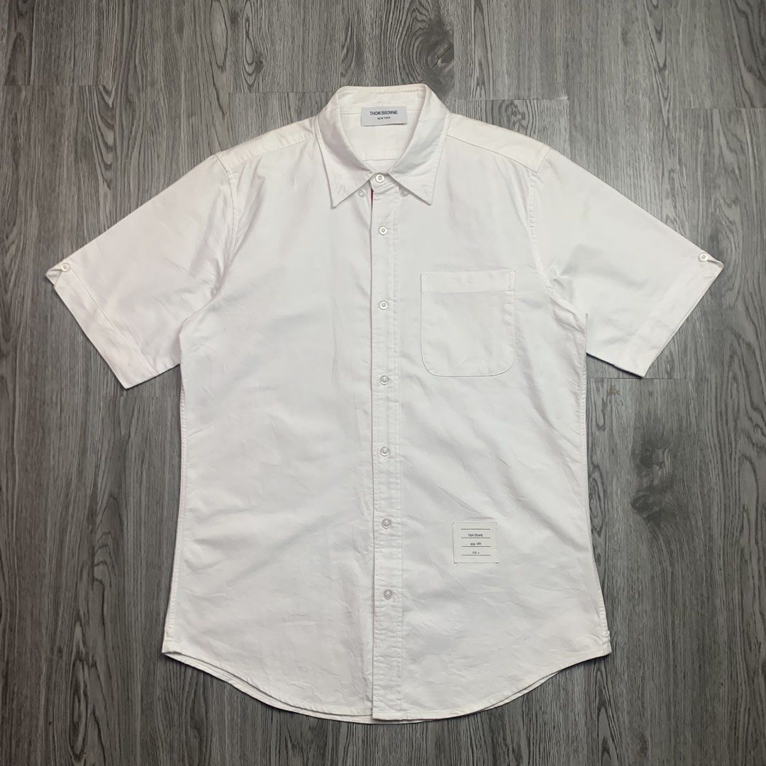 Thom Browne Oxford Button Down Shortsleeve ( White ) (Category: Luxury Apparel) located in Cebu City. Submitted by devourapparel.ph (Listing ID 1454126282, Image 2). Description: WTS! Thom Browne Oxford Button Down Shortsleeve ( White ) - Authentic - Dimes: 21x29 - Color rate: 10/10 - Good as new condition - No issue Price: 3,499.