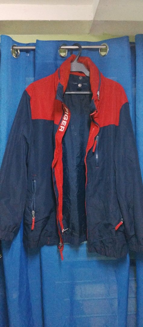 Tommy Hilfiger Colorblock Jacket Navy Red Size L (Category: Coats, Jackets and Outerwear) located in Manila. Submitted by bunshoy09 (Listing ID 1454073330, Image 1). Description: - Tommy Hilfiger Jacket - Color: Navy and Red - Size: Large (L) - Features: Zipper closure, zippered pockets - Collar Detail: 'HILFIGER' print - Lining: Navy - Origin: Made in the Philippines - Condition: Please check photos for details issue: may dlwang zipper na na sto