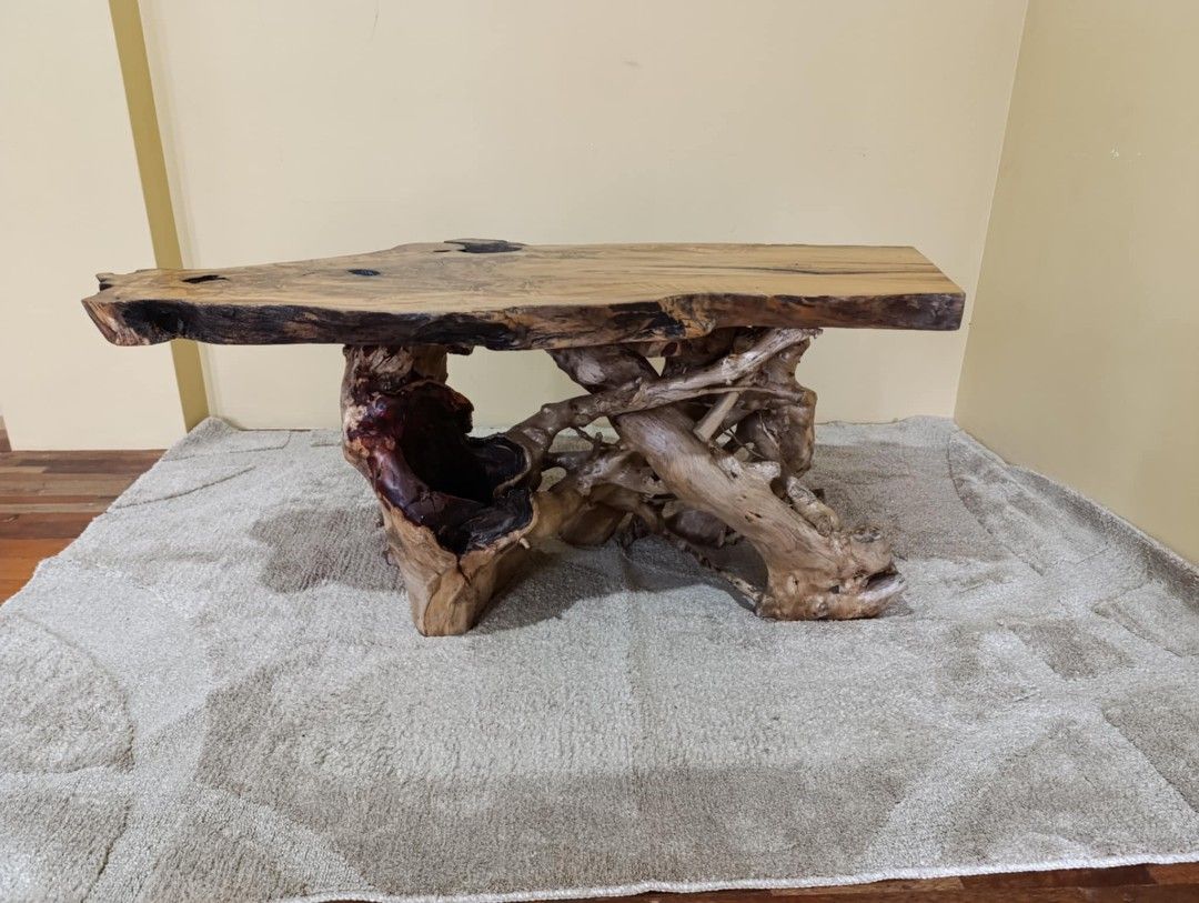 Unique Live Edge Wood Coffee Table with Natural Root Base (Category: Tables & Sets) located in Manila. Submitted by youngflower_9e0e16 (Listing ID 1454151832, Image 1). Description: - One-of-a-kind coffee table - Features a beautiful live edge wood top with natural grain patterns - Base made from intertwined natural roots for a rustic and artistic look - A guaranteed conversation starter for your living space - Measures approximately [insert dime