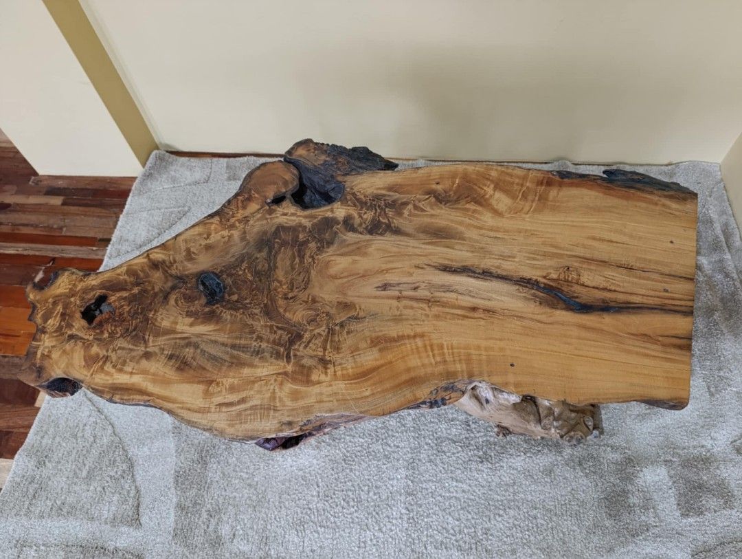 Unique Live Edge Wood Coffee Table with Natural Root Base (Category: Tables & Sets) located in Manila. Submitted by youngflower_9e0e16 (Listing ID 1454151832, Image 2). Description: - One-of-a-kind coffee table - Features a beautiful live edge wood top with natural grain patterns - Base made from intertwined natural roots for a rustic and artistic look - A guaranteed conversation starter for your living space - Measures approximately [insert dime