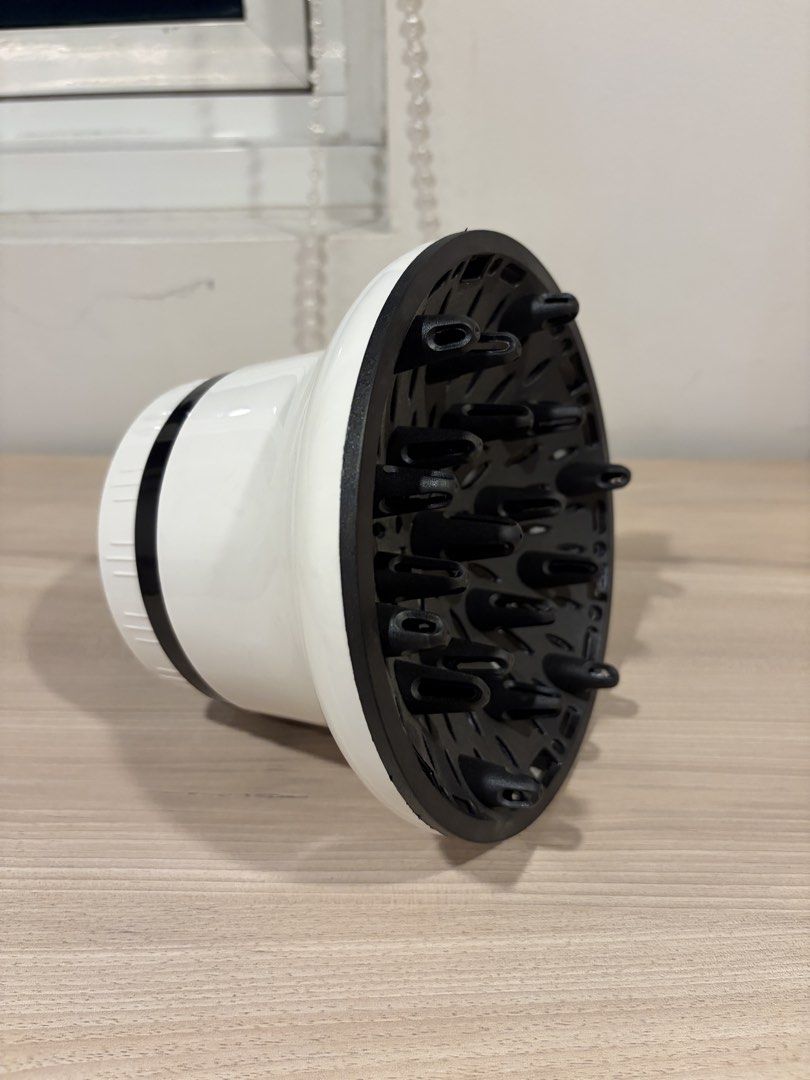 Universal Hair Dryer Diffuser Attachment (Category: Hair) located in Quezon City. Submitted by sparklingberry (Listing ID 1454118995, Image 1). Description: - 8.2cm inner diameter - White and black hair dryer diffuser - Fits most standard hair dryers - Even air distribution for better drying - Ideal for curly or wavy hair - Easy to attach and remove - Achieve salon-quality results at home.