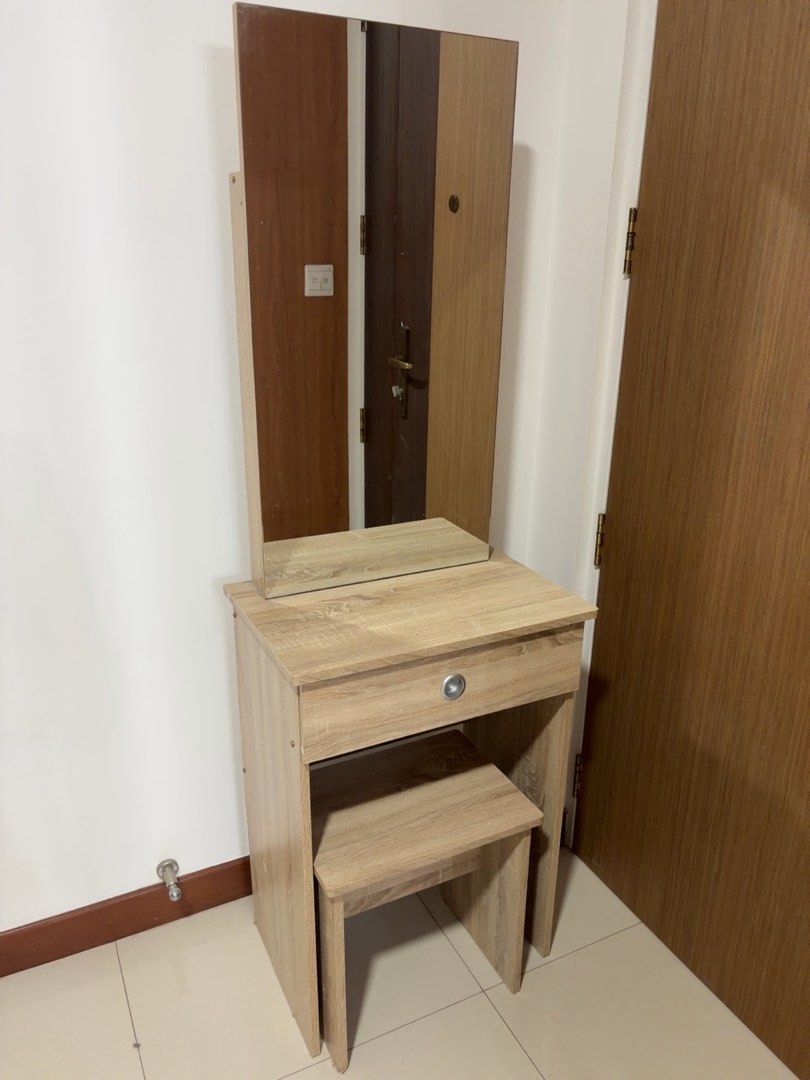 Dressing Table (Category: Other Home Furniture) located in Singapore. Submitted by lorenjann (Listing ID 1454164575, Image 3). Description: - Stylish vanity table set with a large mirror. - Includes a matching stool for comfortable use. - Features a convenient drawer for storage. - Light wood finish for a modern aesthetic. - Compact dimensions: 60cm (W) x 40cm (D) x 130cm (H). - Mirror height: 90cm. - Stool height: 45cm..