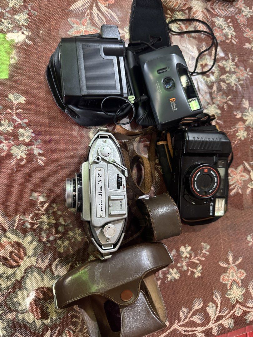 Vintage Camera Bundle: Minolta, Canon, Pmini 2, National Flash (Category: Cameras) located in Cainta. Submitted by danica010314 (Listing ID 1454085924, Image 1). Description: UNTESTED PO LAHAT KAYO NA PO MAG PAGAWA - Bundle includes: Minolta A.2, Canon Auto Focus, Pmini 2 Panorama cameras - Also includes: National 2801 flash unit - Some items come with original leather cases - Ideal for vintage camera collectors - Perfect for film photography ent