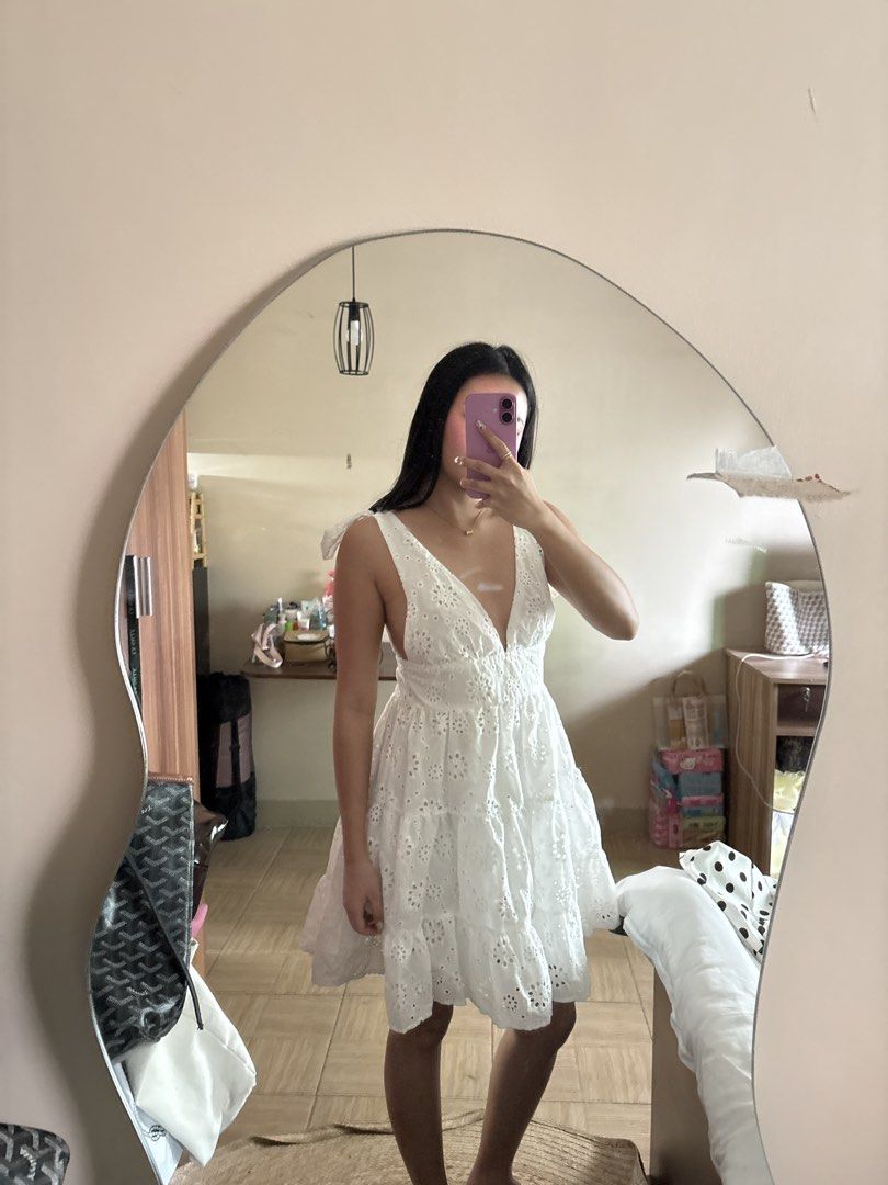 White Eyelet Tie Strap Mini Dress (Category: Dresses) located in Manila. Submitted by _foryou (Listing ID 1454035301, Image 2). Description: - Cute white eyelet mini dress - Plunging neckline with tie shoulder straps - Tiered skirt with eyelet details - Ideal for summer or beach vacations - Lightweight and flowy fabric - Easy to style for any occasion.