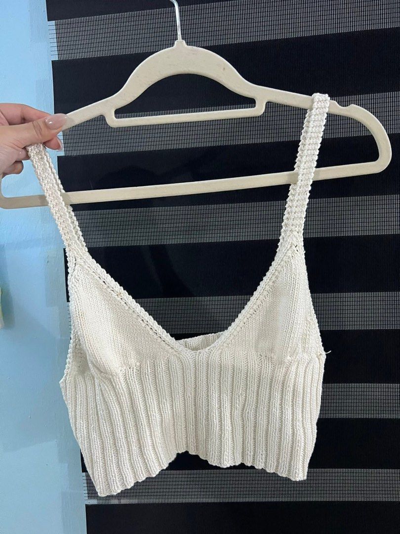 White Knit V-Neck Cropped Tank Top (Category: Sleeveless) located in Manila. Submitted by pmuffy24 (Listing ID 1454169935, Image 1). Description: - White knit tank top - V-neckline with thick straps - Ribbed texture all over - Cropped length - Versatile: pairs well with high-waisted jeans or skirts.