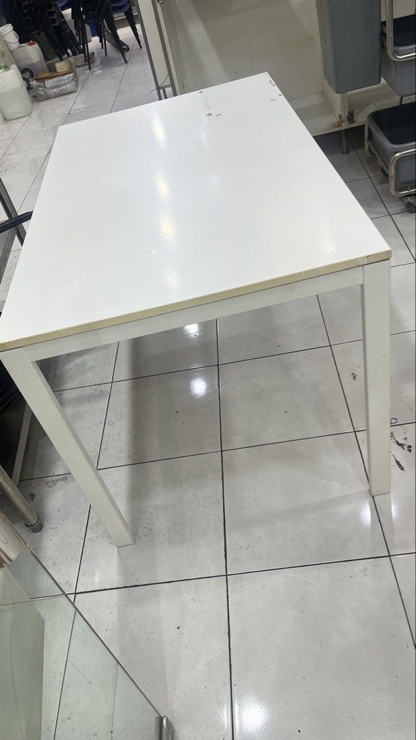 White Rectangular Table (Category: Tables & Sets) located in Petaling Jaya. Submitted by conniep99 (Listing ID 1454061059, Image 1). Description: - Simple and versatile white table - Ideal for dining or as a work desk - Sturdy metal legs for durability - Easy-to-clean surface - Dimensions: Approx. 29.5x49inches(~4ft) - Reason for selling: Moving out.