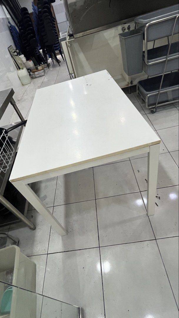 White Rectangular Table (Category: Tables & Sets) located in Petaling Jaya. Submitted by conniep99 (Listing ID 1454061059, Image 2). Description: - Simple and versatile white table - Ideal for dining or as a work desk - Sturdy metal legs for durability - Easy-to-clean surface - Dimensions: Approx. 29.5x49inches(~4ft) - Reason for selling: Moving out.
