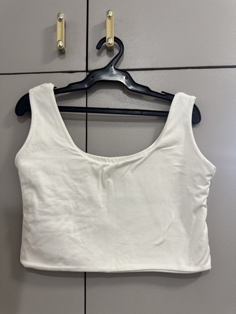 White Sleeveless Cropped Tank Top (Category: Sleeveless) located in Quezon City. Submitted by jaebaeee (Listing ID 1454140210, Image 2). Description: - Basic white cropped tank top - Sleeveless design with a scoop neckline - Simple and versatile: layer or wear alone - Perfect for casual outings or workouts - Stretchy material for ultimate comfort.