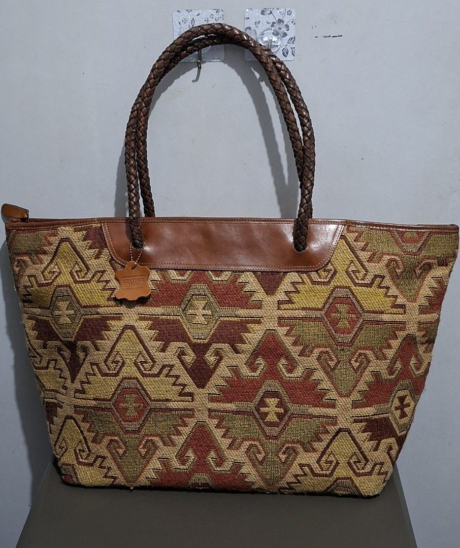 Woven Tapestry Leather Trim Tote Bag (Category: Tote Bags) located in Quezon City. Submitted by moonthrifting (Listing ID 1454038169, Image 1). Description: - Large woven tapestry tote bag - Braided leather handles and trim - Zipper closure for security - Lined with brown leather interior - Ample space for all your essentials - Ideal for everyday use or travel.