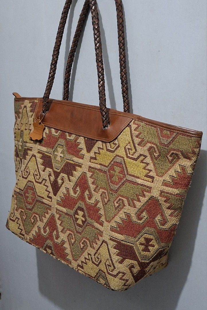 Woven Tapestry Leather Trim Tote Bag (Category: Tote Bags) located in Quezon City. Submitted by moonthrifting (Listing ID 1454038169, Image 2). Description: - Large woven tapestry tote bag - Braided leather handles and trim - Zipper closure for security - Lined with brown leather interior - Ample space for all your essentials - Ideal for everyday use or travel.