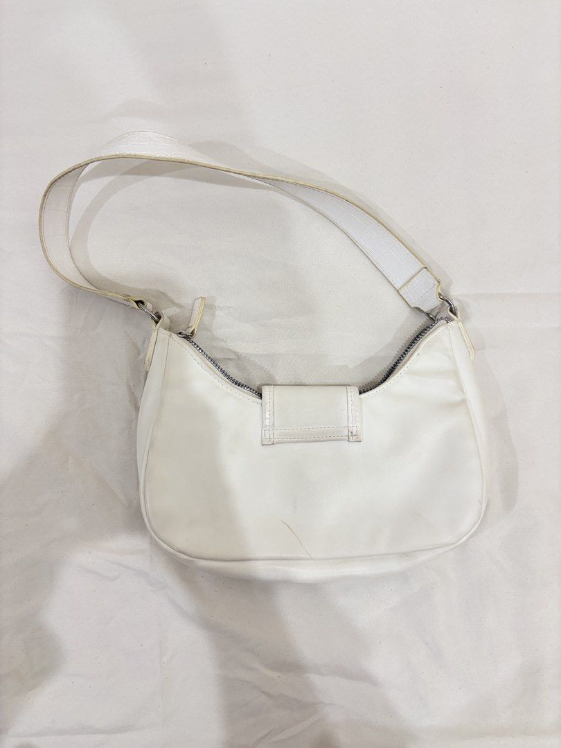 Y2K Style White Shoulder Bag with Silver Hardware (Category: Shoulder Bags) located in Marikina City. Submitted by beadc (Listing ID 1454160330, Image 2). Description: - Cute white shoulder bag - Zipper closure with buckle flap - Adjustable strap - Ideal for everyday use - Some yellowing along the edges.