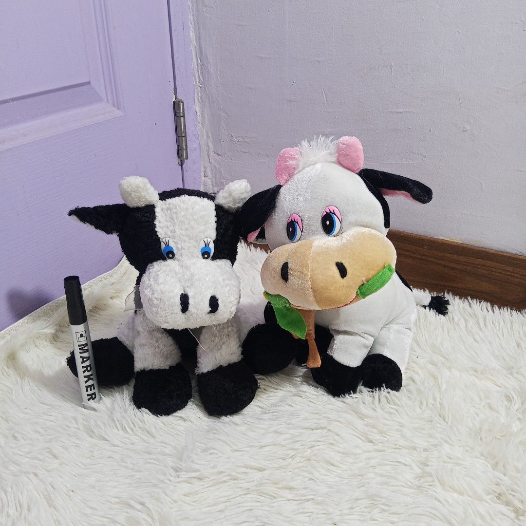 2 Cute Cow Plush Toys (Category: Plushies & Soft Toys) located in Rizal. Submitted by wishaul (Listing ID 1454237710, Image 1). Description: - Adorable cow plushies available! - One black and white cow. - One white cow with pink ears, holding a burger. - Super soft and cuddly. - Ideal for room decoration or as a thoughtful gift. 🚛 Sco (FREE SF) 📍 Rizal.