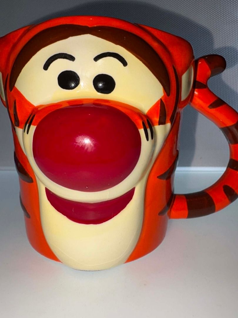 🐯 Disney Tigger 3D Ceramic Mug 🧡☕ (Category: Coffee & Tea Tableware) located in Caloocan City. Submitted by rabbithole2026 (Listing ID 1454359752, Image 1). Description: Fun and collectible Disney Winnie the Pooh Tigger mug featuring Tigger's cheerful face, signature orange stripes, and a uniquely shaped handle. Perfect for coffee, tea, hot chocolate, or displaying as part of a Disney collection. ✅ Official Disney Winnie the Pooh mug ✅ Adorable