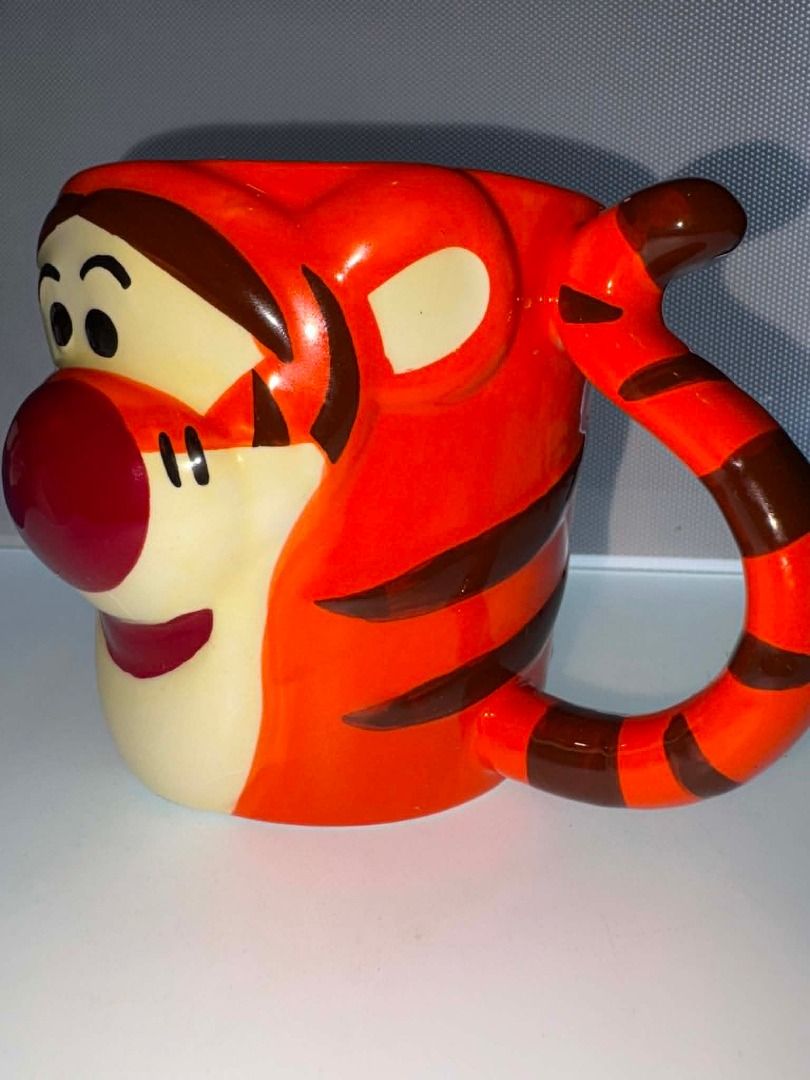 🐯 Disney Tigger 3D Ceramic Mug 🧡☕ (Category: Coffee & Tea Tableware) located in Caloocan City. Submitted by rabbithole2026 (Listing ID 1454359752, Image 2). Description: Fun and collectible Disney Winnie the Pooh Tigger mug featuring Tigger's cheerful face, signature orange stripes, and a uniquely shaped handle. Perfect for coffee, tea, hot chocolate, or displaying as part of a Disney collection. ✅ Official Disney Winnie the Pooh mug ✅ Adorable