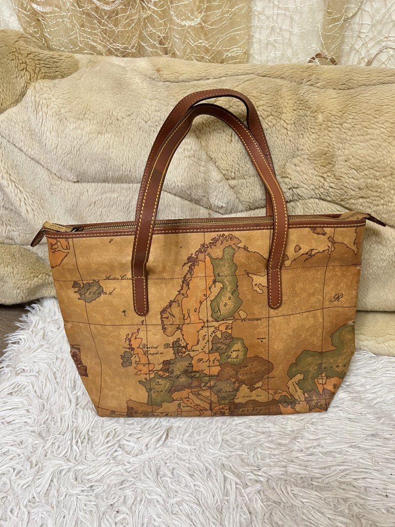 Alviero Martini Geo Map Tote Bag (Category: Luxury Bags & Wallets) located in Valenzuela. Submitted by preloved.by.ashley (Listing ID 1454235622, Image 1). Description: -Alviero Martini tote bag - Iconic Geo Map print - Genuine leather trim and handles - Secure zipper closure - Minor wear on bottom corners (as pictured) - Ideal for travel or everyday use.