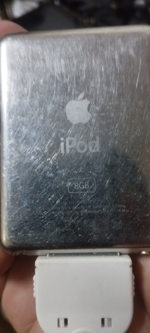 Apple iPod nano 3rd gen 8GB Silver (Category: Portable Music Players) located in Taguig. Submitted by sonnydela.cruz (Listing ID 1454364006, Image 2). Description: - Apple iPod Classic (8GB) - Ideal for storing your entire music library - Features menu options for Music, Videos, Photos, Podcasts, Extras, and Shuffle Songs - Classic Apple logo and iPod branding on the back - Casing shows some signs of wear, consistent with a beloved classic tech p