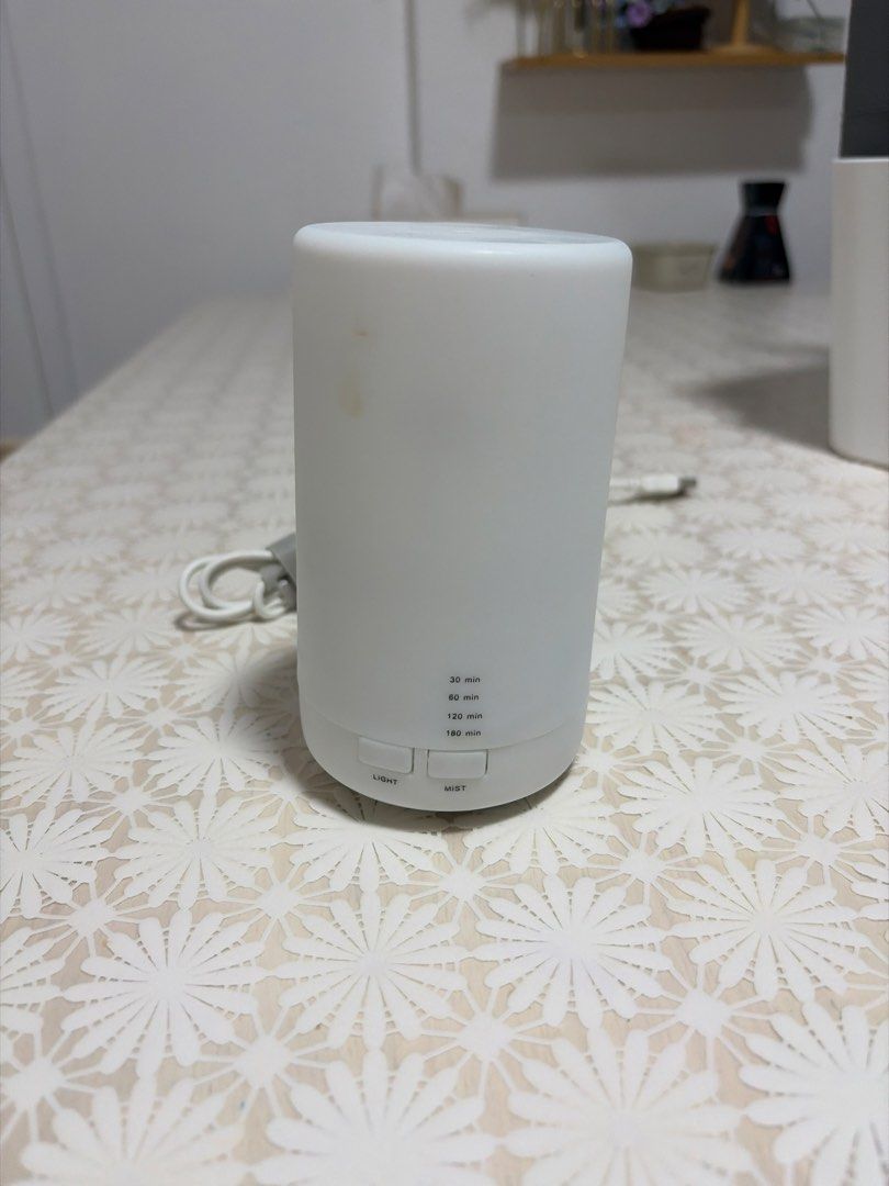 Aromatic Essential Oil Diffuser (Category: Home Fragrance) located in Singapore. Submitted by charr29 (Listing ID 1454332239, Image 1). Description: - White essential oil diffuser - Features light and mist functions - Multiple timer settings: 30, 60, 120, 180 minutes - Easy to operate with simple buttons - Compact and modern design.
