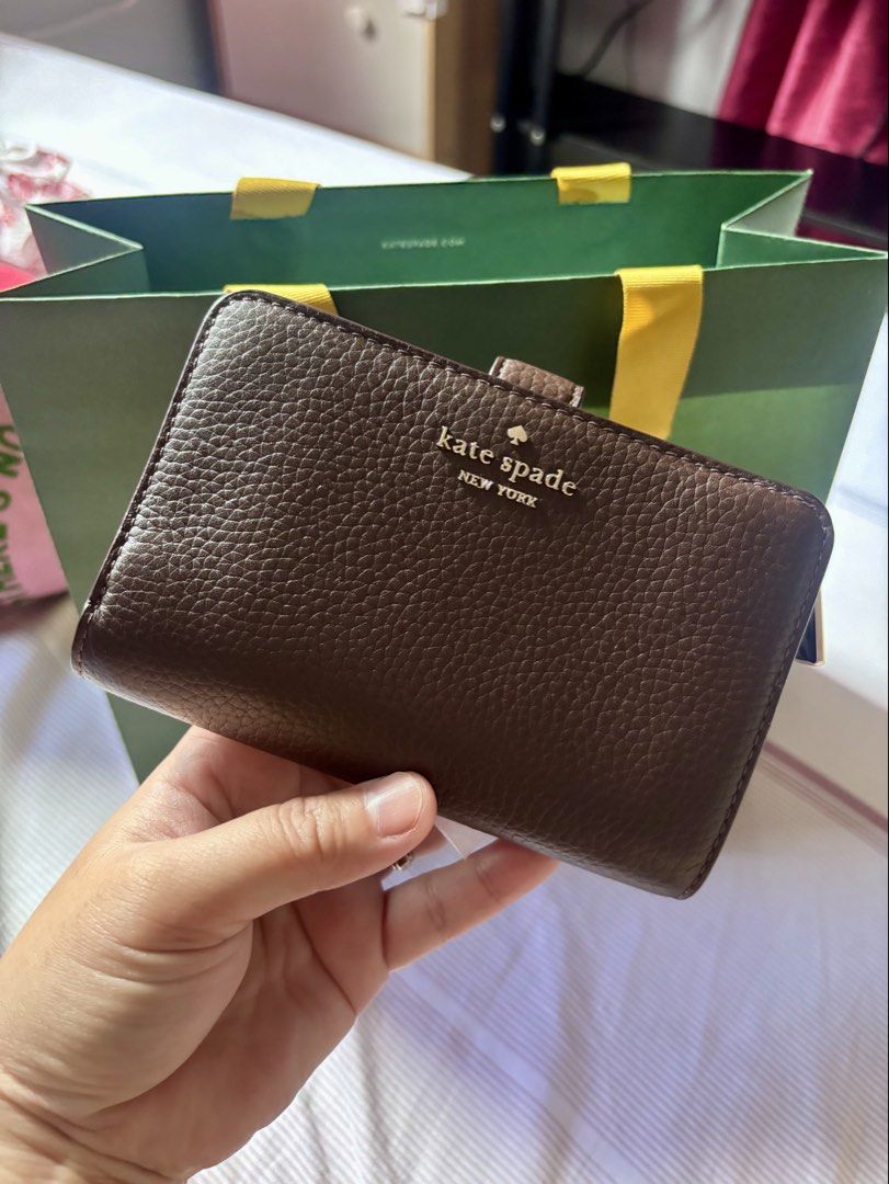 AUTHENTIC & IMPORTED Kate Spade Hot Fudge Medium Wallet (Category: Wallets & Card holders) located in Malolos. Submitted by cheerz21 (Listing ID 1454212144, Image 1). Description: Authentic & Imported Lena Kate Spade Medium Wallet Material: Pebbled Leather Color: Hot Fudge MINT Condition Barely used, good as new w/ paper bag If in doubt don’t buy. No return, no exchange. 📌 Disclaimer: Cheerz21 is not affiliated, associated, or in any way connect