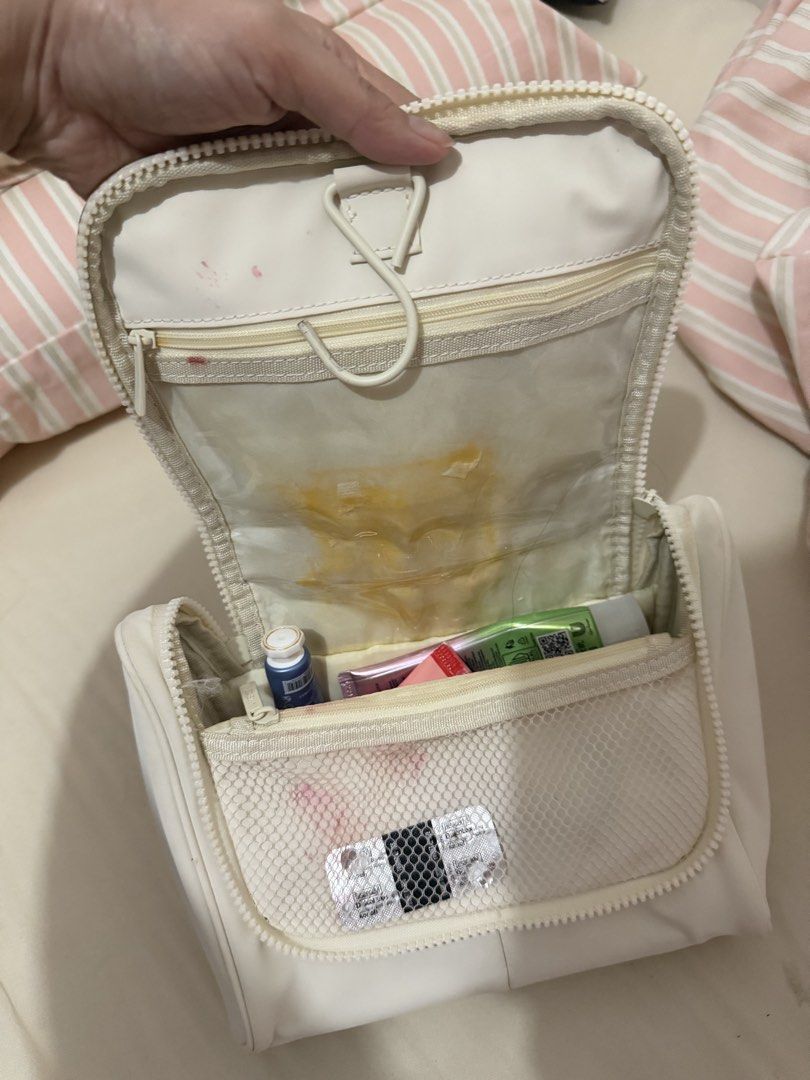 Bash White Cosmetic Bag with Hook (Category: Purses & Pouches) located in Davao. Submitted by fabdeclutter (Listing ID 1454361760, Image 2). Description: - White cosmetic bag - Built-in hook for convenient hanging - Multiple internal compartments for organization - Front mesh pocket - Secure zipper closure - Note: Some stains inside main compartment and on mesh pocket.