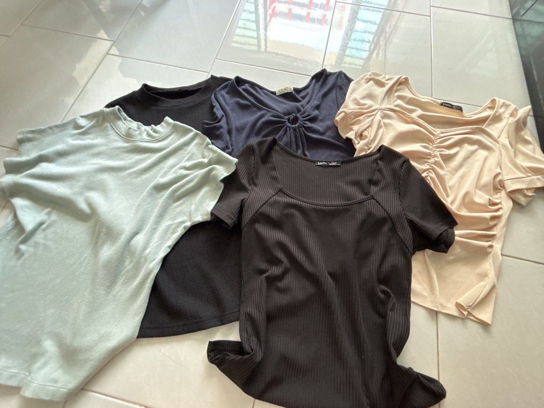 Basic tops (Category: Blouses) located in Singapore. Submitted by sugarsister (Listing ID 1454258158, Image 1). Description: $5 per piece Buy more eligible for discount:) Includes a light mint green ribbed top, a black ribbed square neck top, a navy blue knotted top, a black textured top, and a light peach ruched top. All tops are short-sleeved. Great for casual wear or dressing up..