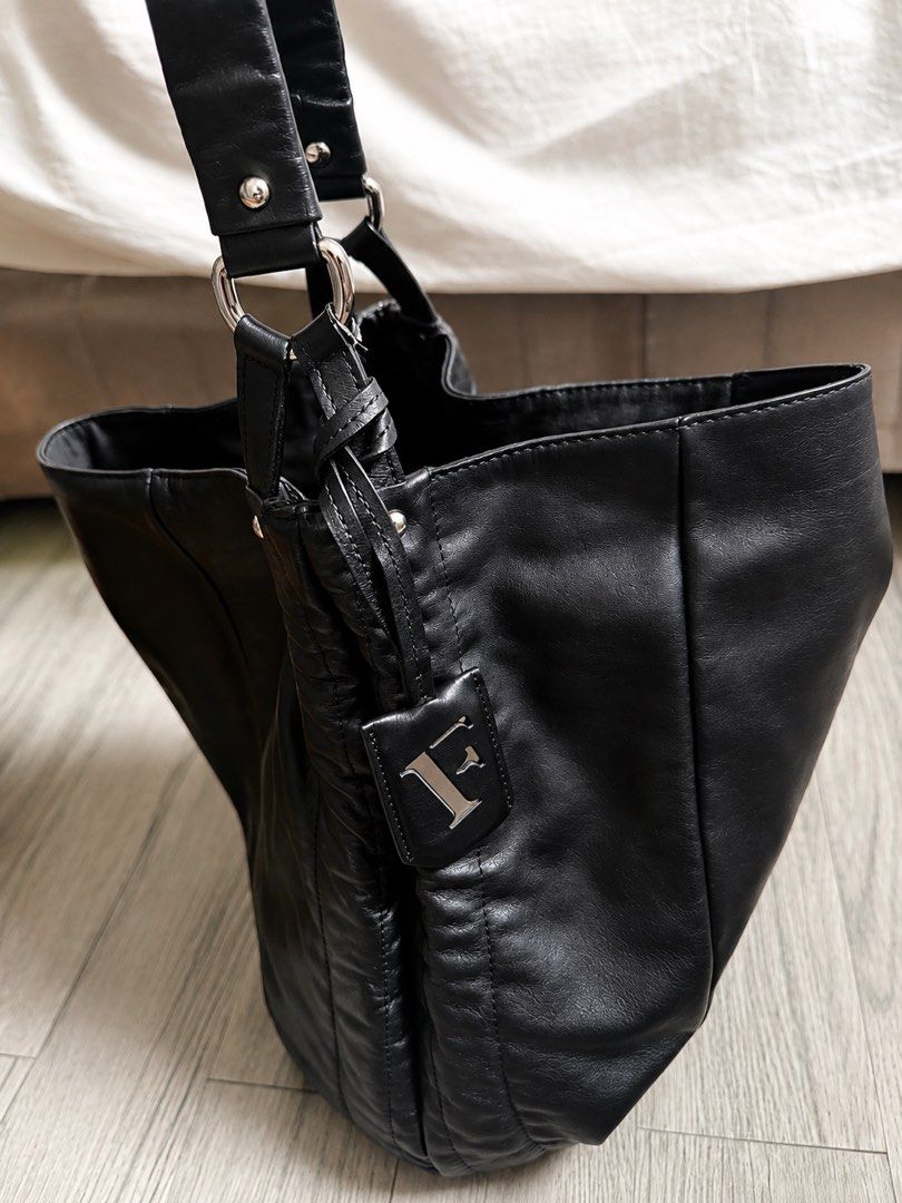 Black Leather Shoulder Bag with 'F' Logo (Category: Shoulder Bags) located in Antipolo. Submitted by 2003preloved (Listing ID 1454209381, Image 2). Description: - Soft, slouchy black leather shoulder bag - Iconic 'F' logo charm - Elegant silver hardware details - Comfortable shoulder straps - Ample interior space for essentials - Your perfect everyday companion.