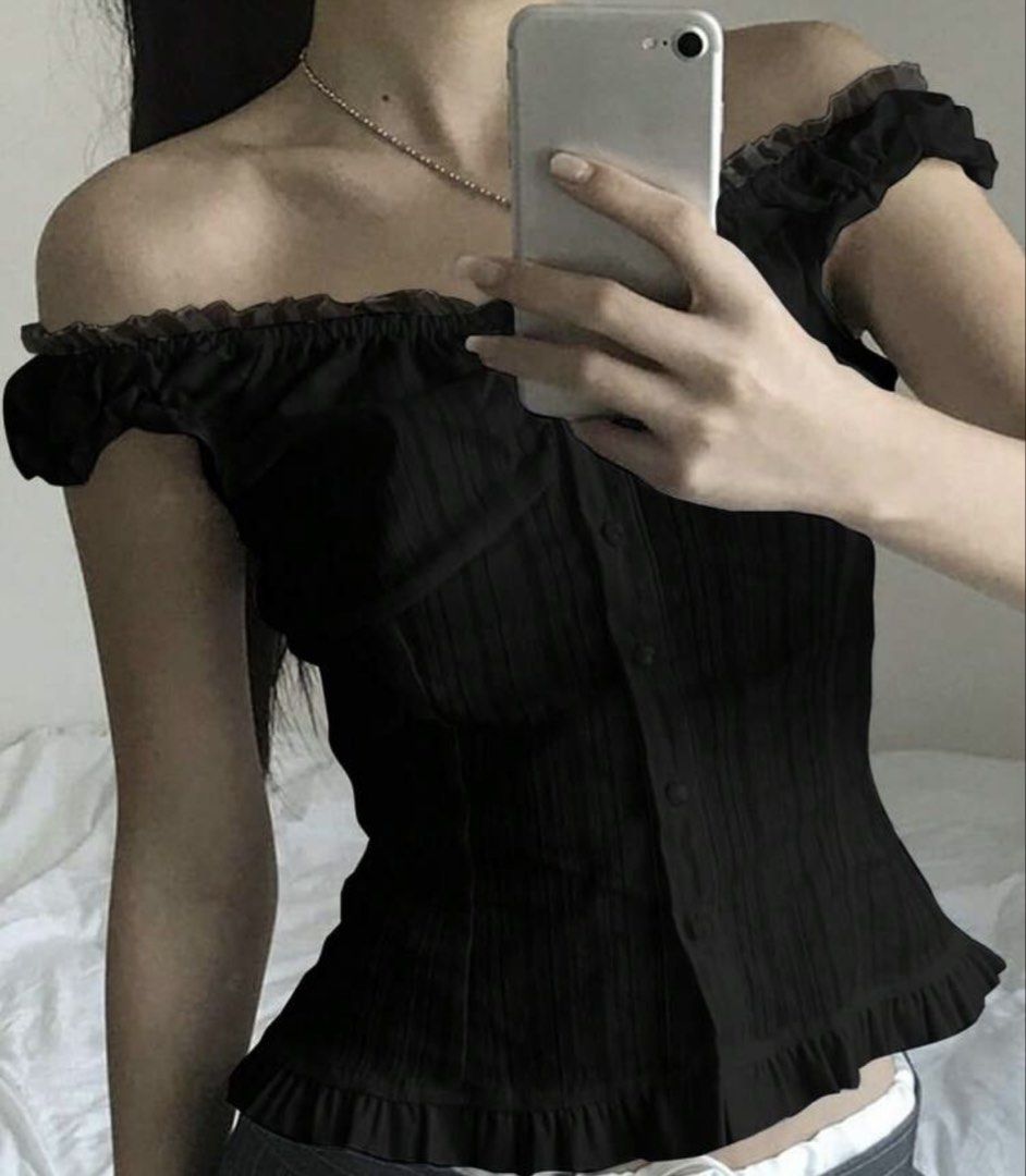Black Off-Shoulder Ruffle Corset Top (Category: Others Tops) located in Bacolod City. Submitted by angelsantii (Listing ID 1454201044, Image 1). Description: - Chic black off-shoulder top - Features charming ruffles on neckline and hem - Functional buttons down the front - Textured ribbed fabric for a stylish look - Flattering fit that enhances your silhouette - Versatile piece: pairs perfectly with jeans or skirts.