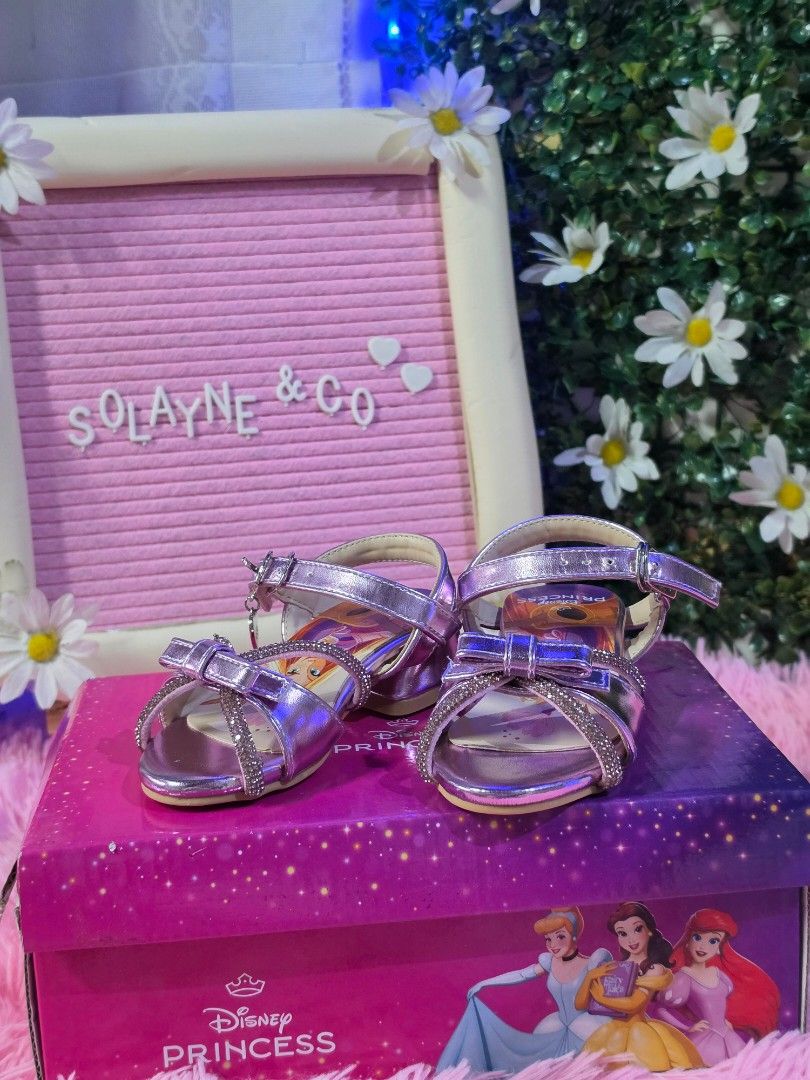 CastroDisney Princess Sandals ✨ (Category: Babies & Kids Fashion) located in Mandaluyong City. Submitted by hellokrissel (Listing ID 1454199633, Image 2). Description: Disney Princess Sandals 👡 Size: 24 🎨 Color: Purple 🌸 Original Price: ₱1,399 🌸 Selling for only: ₱1,000 🌸 Used only once – worn during my daughter's 2nd birthday photoshoot. 📝 Note: The heart chain is no longer included. Please refer to the photos for the actual condition. 📍 