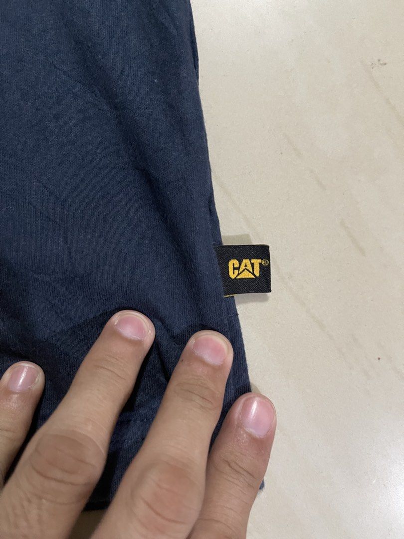 CAT T-Shirt Size M Navy Blue (Category: Tshirts & Polo Shirts ) located in Manila. Submitted by stuzzygod (Listing ID 1454343651, Image 3). Description: - Navy blue CAT t-shirt - Features classic CAT logo on front - Made from 100% cotton - Tagged size M - Ideal for casual wear - Dimes 21.5x28 - No issue - Good condition.