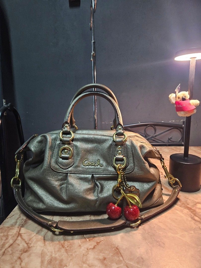 Coach Ashley Satchel - Bronze (Category: Luxury Bags & Wallets) located in Angono. Submitted by juleespreloved (Listing ID 1454266775, Image 1). Description: Authentic Coach ✨️ Comes with: Original Shoulder Strap, Hangtag Condition: Excellent, Used only once. Hardware Condition: 90% above Location: Angono, Rizal MOD: JnT or Lalamove (if around Metro Manila and Rizal) Payment first basis, videocall all you want. DM Me! 🍒.