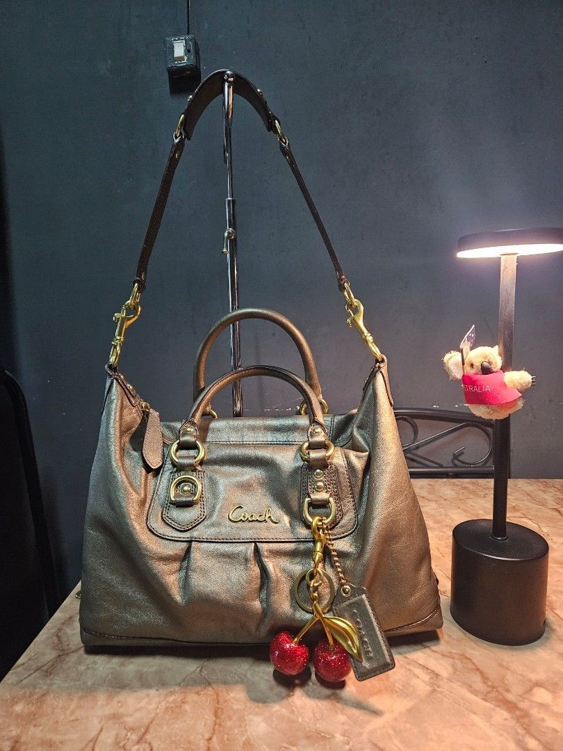 Coach Ashley Satchel - Bronze (Category: Luxury Bags & Wallets) located in Angono. Submitted by juleespreloved (Listing ID 1454266775, Image 2). Description: Authentic Coach ✨️ Comes with: Original Shoulder Strap, Hangtag Condition: Excellent, Used only once. Hardware Condition: 90% above Location: Angono, Rizal MOD: JnT or Lalamove (if around Metro Manila and Rizal) Payment first basis, videocall all you want. DM Me! 🍒.