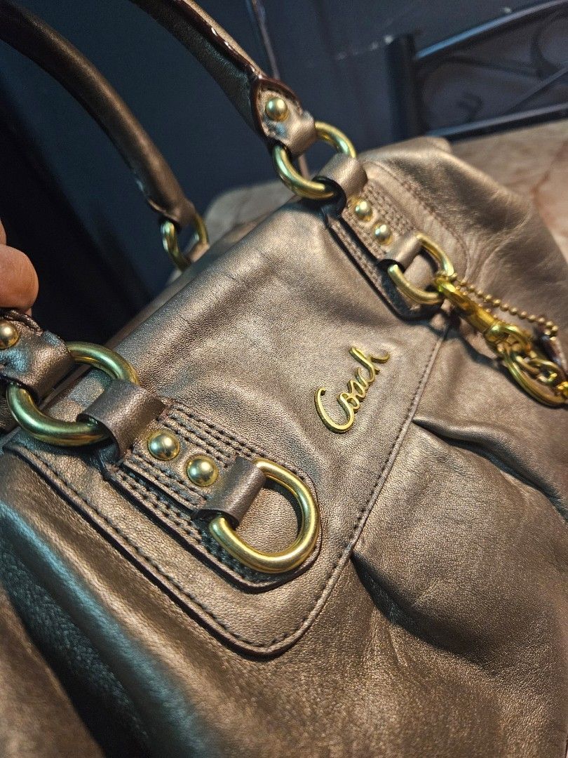 Coach Ashley Satchel - Bronze (Category: Luxury Bags & Wallets) located in Angono. Submitted by juleespreloved (Listing ID 1454266775, Image 3). Description: Authentic Coach ✨️ Comes with: Original Shoulder Strap, Hangtag Condition: Excellent, Used only once. Hardware Condition: 90% above Location: Angono, Rizal MOD: JnT or Lalamove (if around Metro Manila and Rizal) Payment first basis, videocall all you want. DM Me! 🍒.