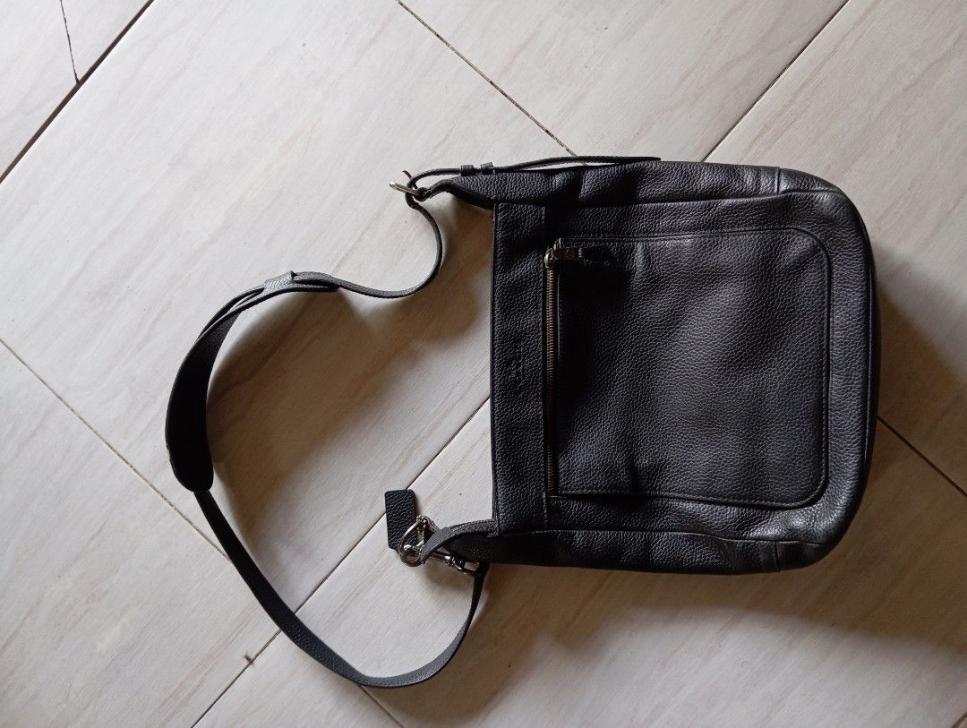 Coach Black Leather Crossbody Bag (Category: Cross-body Bags) located in Manila. Submitted by jzk25 (Listing ID 1454188256, Image 1). Description: - Genuine black leather crossbody bag - Features a convenient front zip pocket - Spacious main compartment for essentials - Adjustable strap for comfortable wear - Durable metal hardware - Note: Slight signs of wear on strap attachments - Interior is clean and well-maintained - Ideal for everyday use a