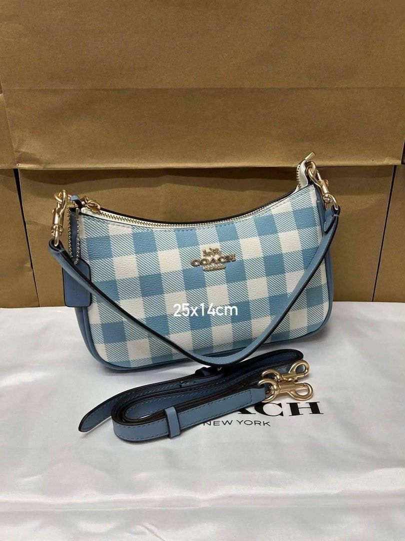 Coach Blue Gingham Cherry Charm Shoulder Bag (Category: Luxury Bags & Wallets) located in Pagsanjan. Submitted by jecay00 (Listing ID 1454282843, Image 2). Description: - Adorable blue gingham Coach shoulder bag - Comes with a cute cherry charm - Features a detachable strap for versatility - Compact size: 25x14cm - Stylish gold hardware details - Ideal for everyday wear or evening outings.
