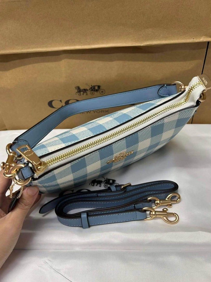 Coach Blue Gingham Cherry Charm Shoulder Bag (Category: Luxury Bags & Wallets) located in Pagsanjan. Submitted by jecay00 (Listing ID 1454282843, Image 3). Description: - Adorable blue gingham Coach shoulder bag - Comes with a cute cherry charm - Features a detachable strap for versatility - Compact size: 25x14cm - Stylish gold hardware details - Ideal for everyday wear or evening outings.
