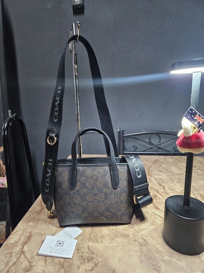 Coach Mini City Tote - Walnut Black (Category: Luxury Bags & Wallets) located in Angono. Submitted by juleespreloved (Listing ID 1431735963, Image 2). Description: Authentic Coach Mini City Tote - Outlet bought Comes with original wide strap, hangtag and carecard Good as new and used only once RFS: Di sya bagay sa body frame ko so I had to let it go nalang instead of not using it. Message me. 🥰.