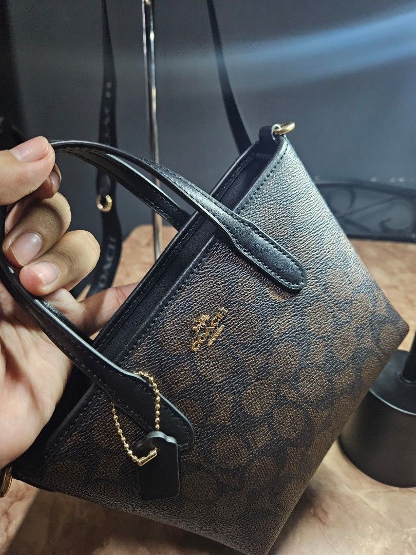 Coach Mini City Tote - Walnut Black (Category: Luxury Bags & Wallets) located in Angono. Submitted by juleespreloved (Listing ID 1431735963, Image 3). Description: Authentic Coach Mini City Tote - Outlet bought Comes with original wide strap, hangtag and carecard Good as new and used only once RFS: Di sya bagay sa body frame ko so I had to let it go nalang instead of not using it. Message me. 🥰.