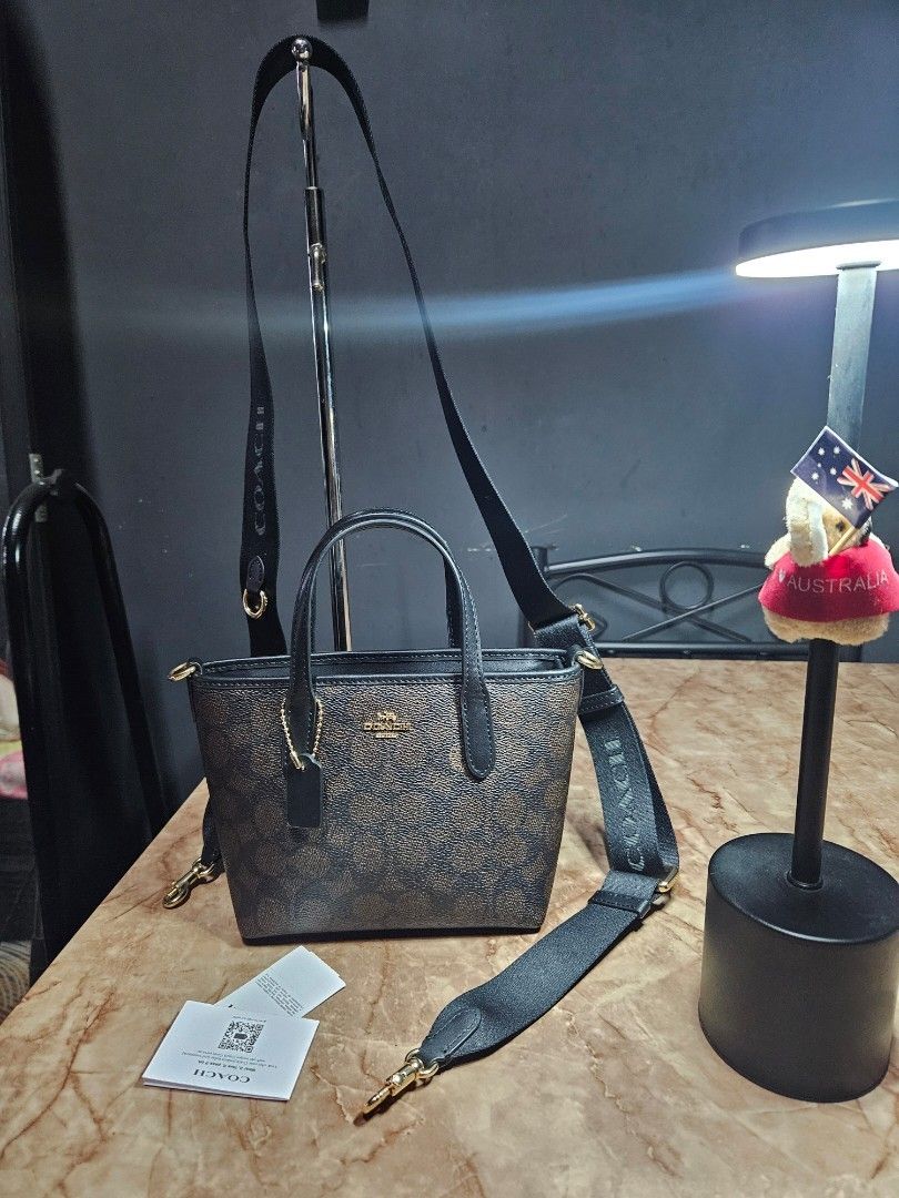 Coach Mini City Tote - Walnut Black (Category: Luxury Bags & Wallets) located in Angono. Submitted by juleespreloved (Listing ID 1431735963, Image 1). Description: Authentic Coach Mini City Tote - Outlet bought Comes with original wide strap, hangtag and carecard Good as new and used only once RFS: Di sya bagay sa body frame ko so I had to let it go nalang instead of not using it. Message me. 🥰.