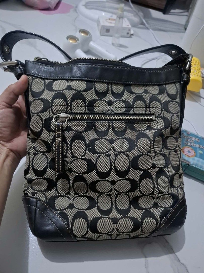 Coach Monogram Canvas Leather Trim Shoulder Bag (Category: Luxury Bags & Wallets) located in Manila. Submitted by mightybear-e67cd9 (Listing ID 1454286521, Image 2). Description: - Classic Coach monogram shoulder bag - Durable canvas body with leather trim and strap - Secure top zipper closure - Convenient front zipper pocket - Perfect for everyday use - Shows some signs of wear, but plenty of life left.