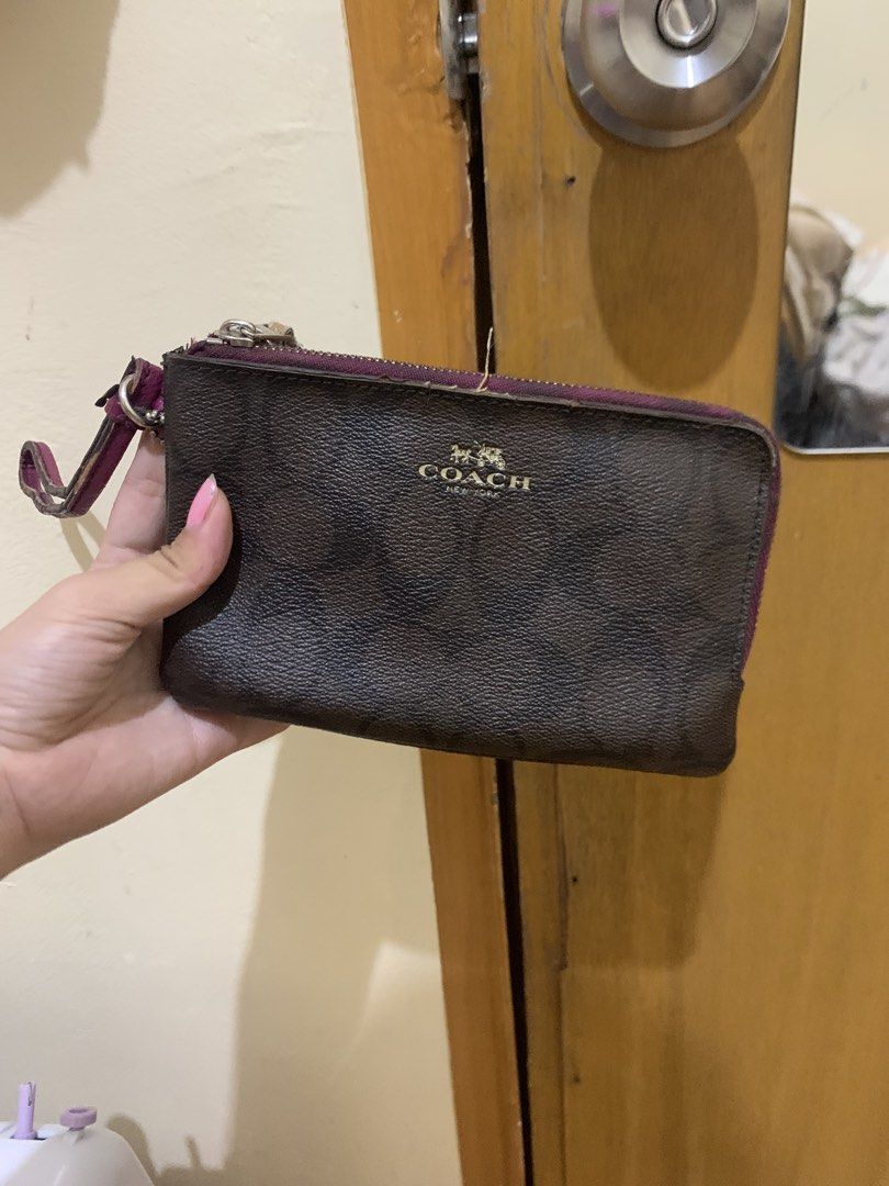 Coach Signature Canvas Double Zip Wristlet (Category: Luxury Bags & Wallets) located in Caloocan City. Submitted by necifinds (Listing ID 1454360723, Image 1). Description: - Coach wristlet in signature brown canvas - Deep purple trim and strap - Two zippered compartments for organization - Strap shows some wear and tear - Zippers are functional - check issues.