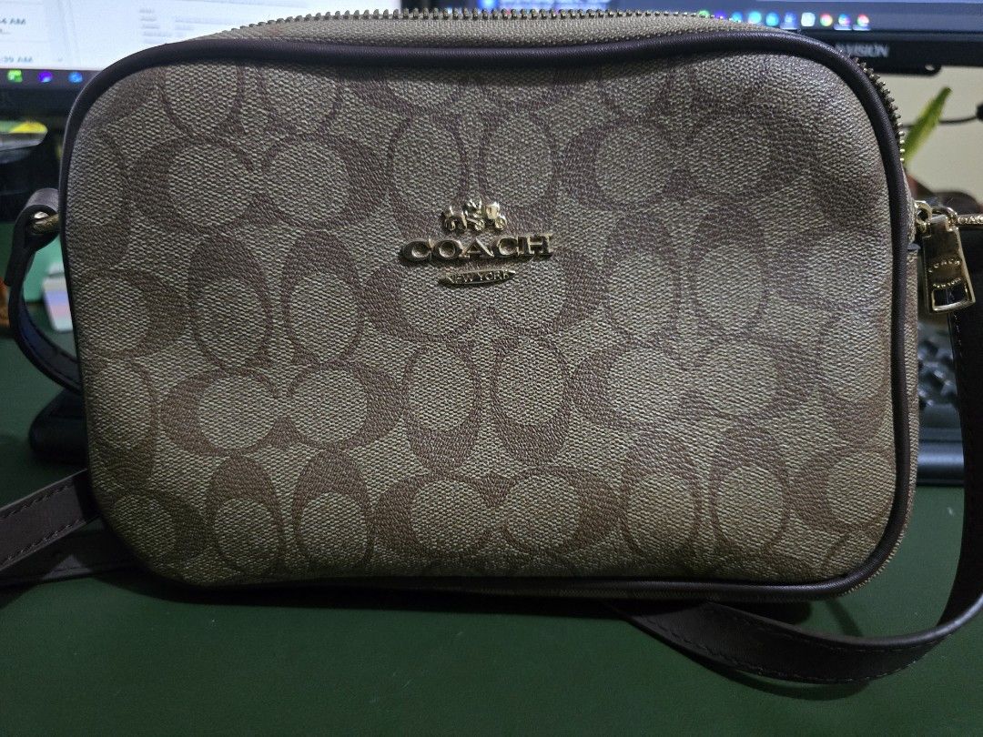 Coach Signature Monogram Crossbody Bag (Category: Luxury Bags & Wallets) located in Imus. Submitted by ur_style (Listing ID 1454311610, Image 1). Description: - Classic Coach crossbody bag - Signature monogram print (brown & tan) - Gold hardware details - Secure zipper closure - Adjustable strap for comfort - Ideal for everyday use or travel - Spacious enough for essentials.