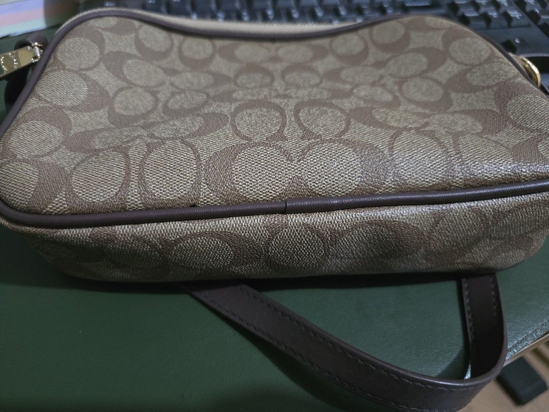 Coach Signature Monogram Crossbody Bag (Category: Luxury Bags & Wallets) located in Imus. Submitted by ur_style (Listing ID 1454311610, Image 2). Description: - Classic Coach crossbody bag - Signature monogram print (brown & tan) - Gold hardware details - Secure zipper closure - Adjustable strap for comfort - Ideal for everyday use or travel - Spacious enough for essentials.