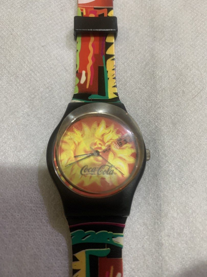 Coca-Cola Swatch Watch - Colorful Strap (Category: Men's Watches) located in Antipolo. Submitted by cebb888 (Listing ID 1454202491, Image 2). Description: - Vintage Coca-Cola watch - Vibrant, colorful strap with Coca-Cola logo - Yellow sunburst watch face with Coca-Cola branding - Perfect collectible for Coca-Cola enthusiasts - Adjustable strap -where is as is . -collectible item only .