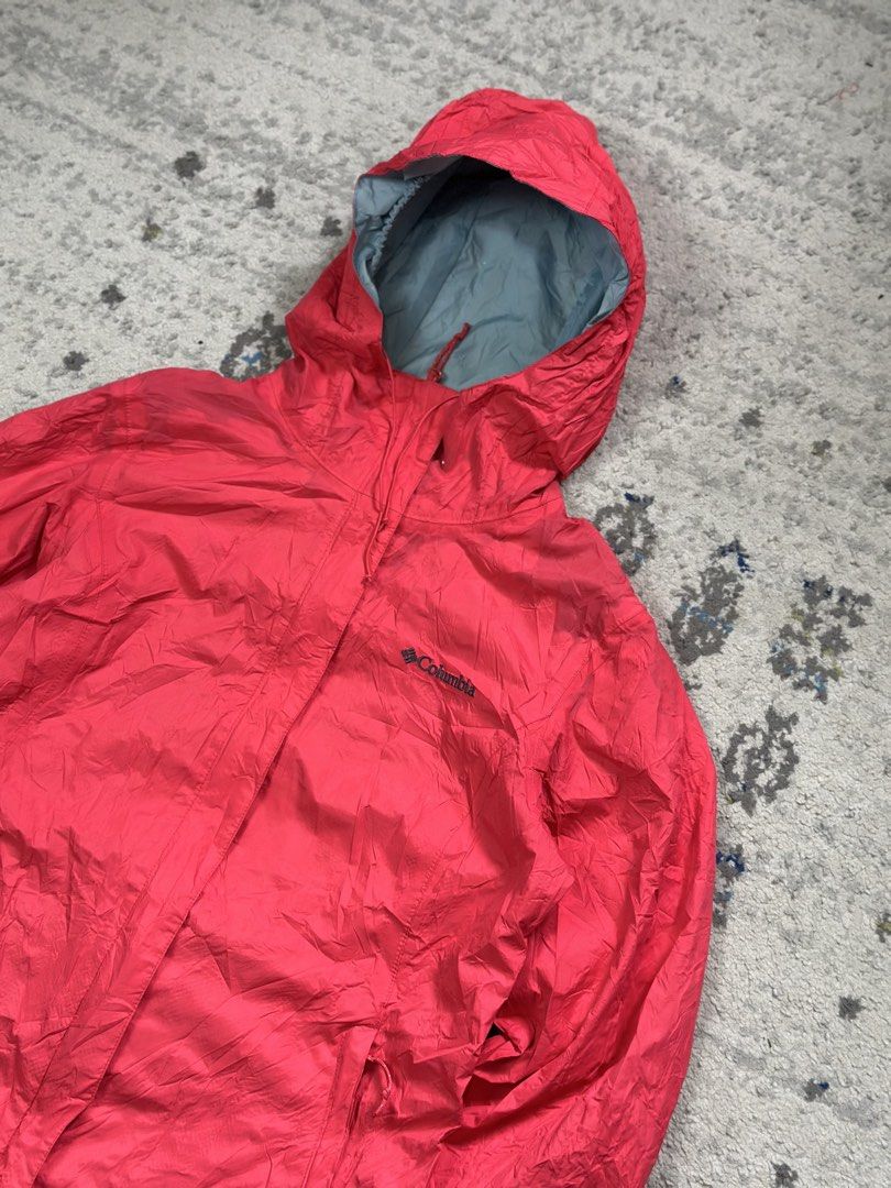 Columbia Packable Rain Jacket - Red (Category: Coats, Jackets and Outerwear) located in Daet. Submitted by thrifthings2018 (Listing ID 1454199687, Image 3). Description: - Columbia packable rain jacket in vibrant red. - Ultra-lightweight and easy to pack for on-the-go. - Features a protective hood and adjustable drawstring hem. - Ideal for unexpected downpours or outdoor excursions. - Measurements: Width 21 inches, Length 26 inches..