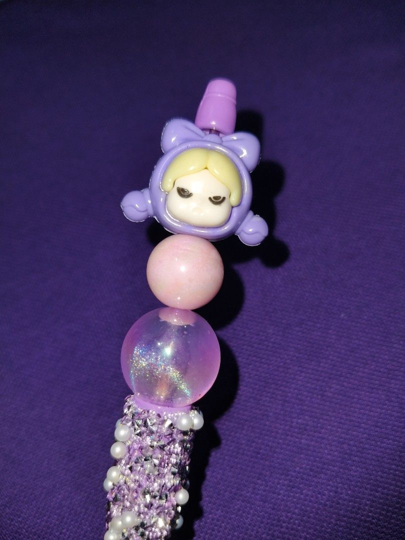 Cute Beaded Pen with Character Topper (Category: Handmade Craft) located in Marikina City. Submitted by cloudycookie22 (Listing ID 1454363459, Image 2). Description: - Handmade beaded pen - Features a cute character topper - Adorned with sparkly purple beads - Light purple pen barrel - Ideal for journaling or desk decor - Makes a wonderful gift.